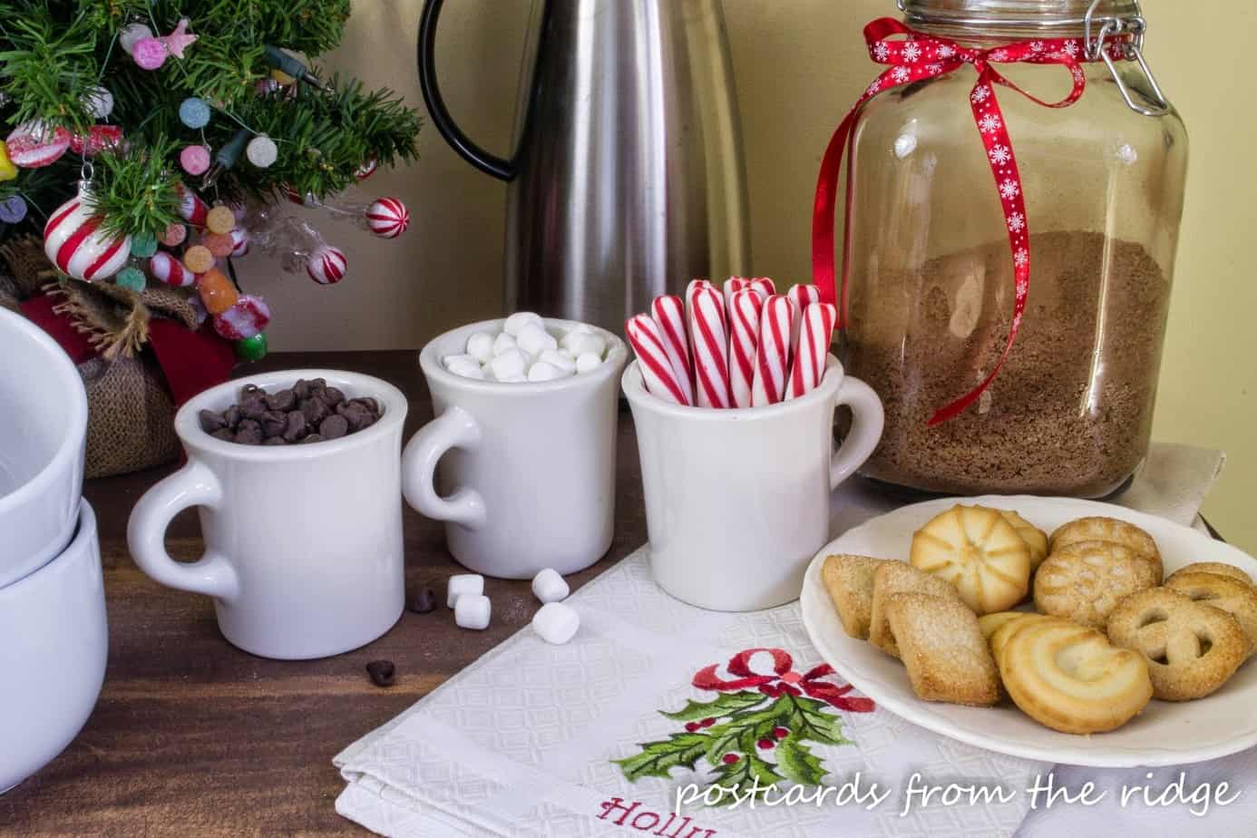 Such a pretty hot cocoa bar using vintage Homer Laughlin mugs for fun additions. Love the embroidered linen too.