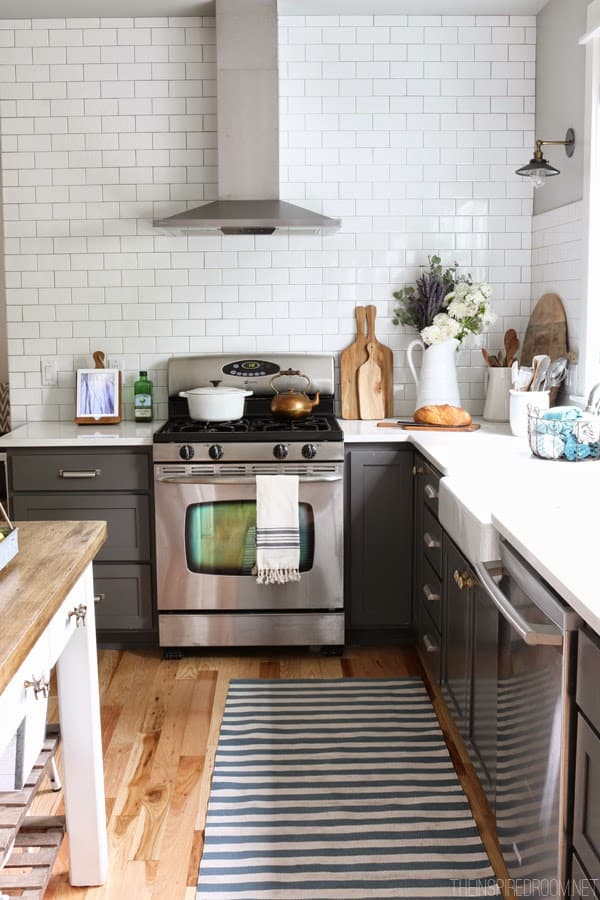 Gorgeous cabinets painted in Benjamin Moore Kendall Charcoal with white subway tile. Swooning! From The Inspired Room.