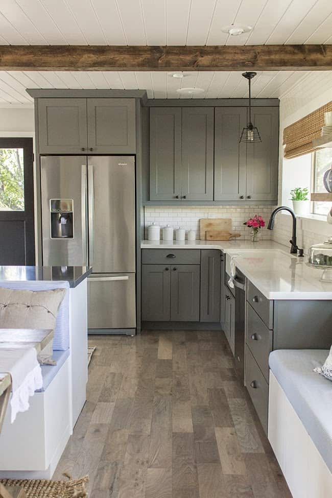 Beautiful remodeled kitchen with gray cabinets and white subway tile.