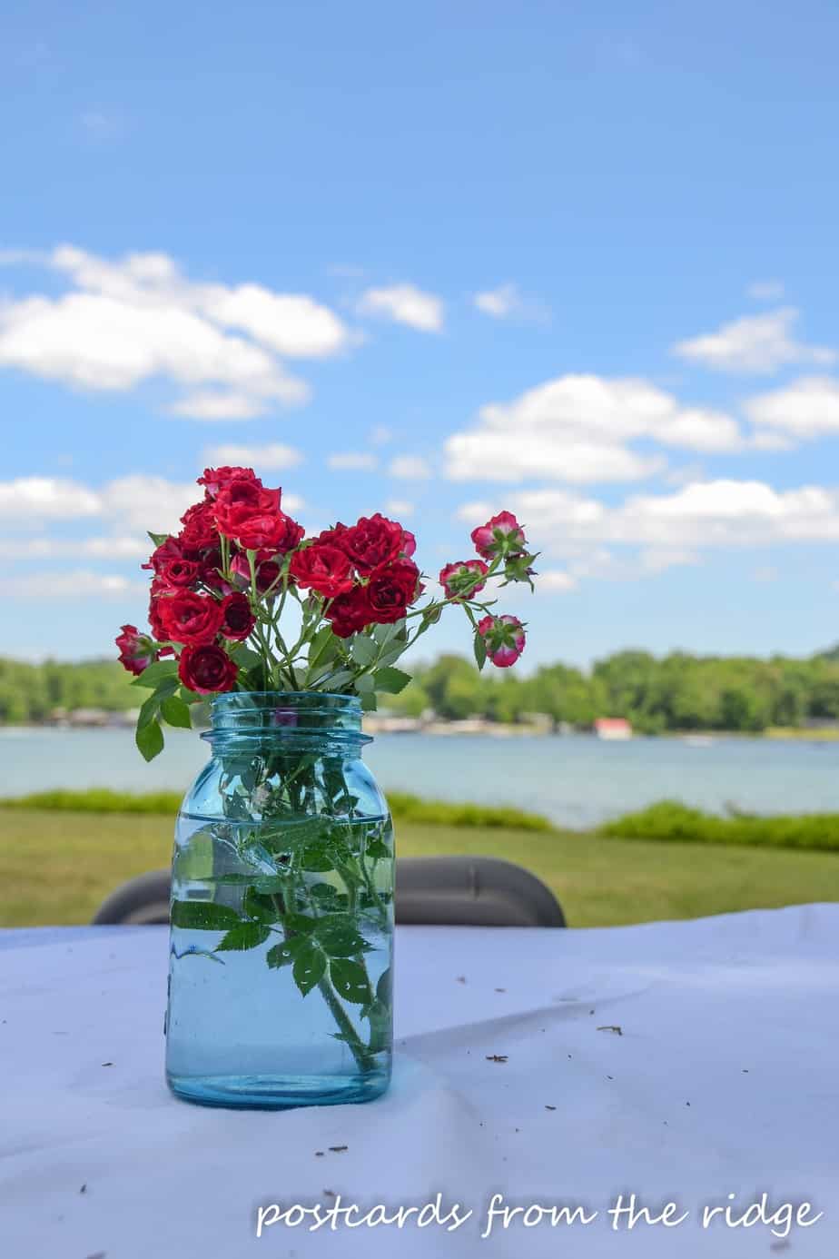 red roses in a vintage blue mason jar