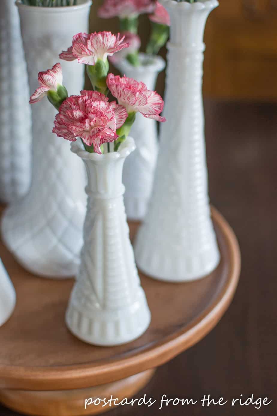 Such a sweet little milk glass vase with carnations. Nice centerpiece.