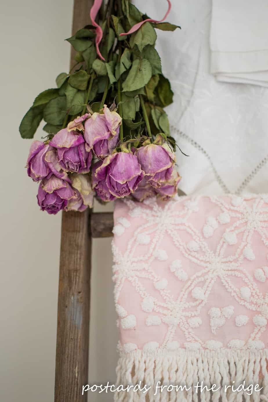 Dried roses and vintage linens on an old ladder. Great ideas on this site. Postcards from the Ridge.