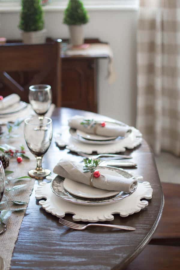 table set for Christmas with vintage dishes, natural and rustic decor