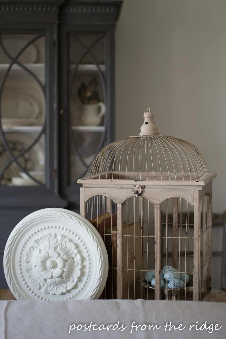 ceramic bird eggs in a bird cage