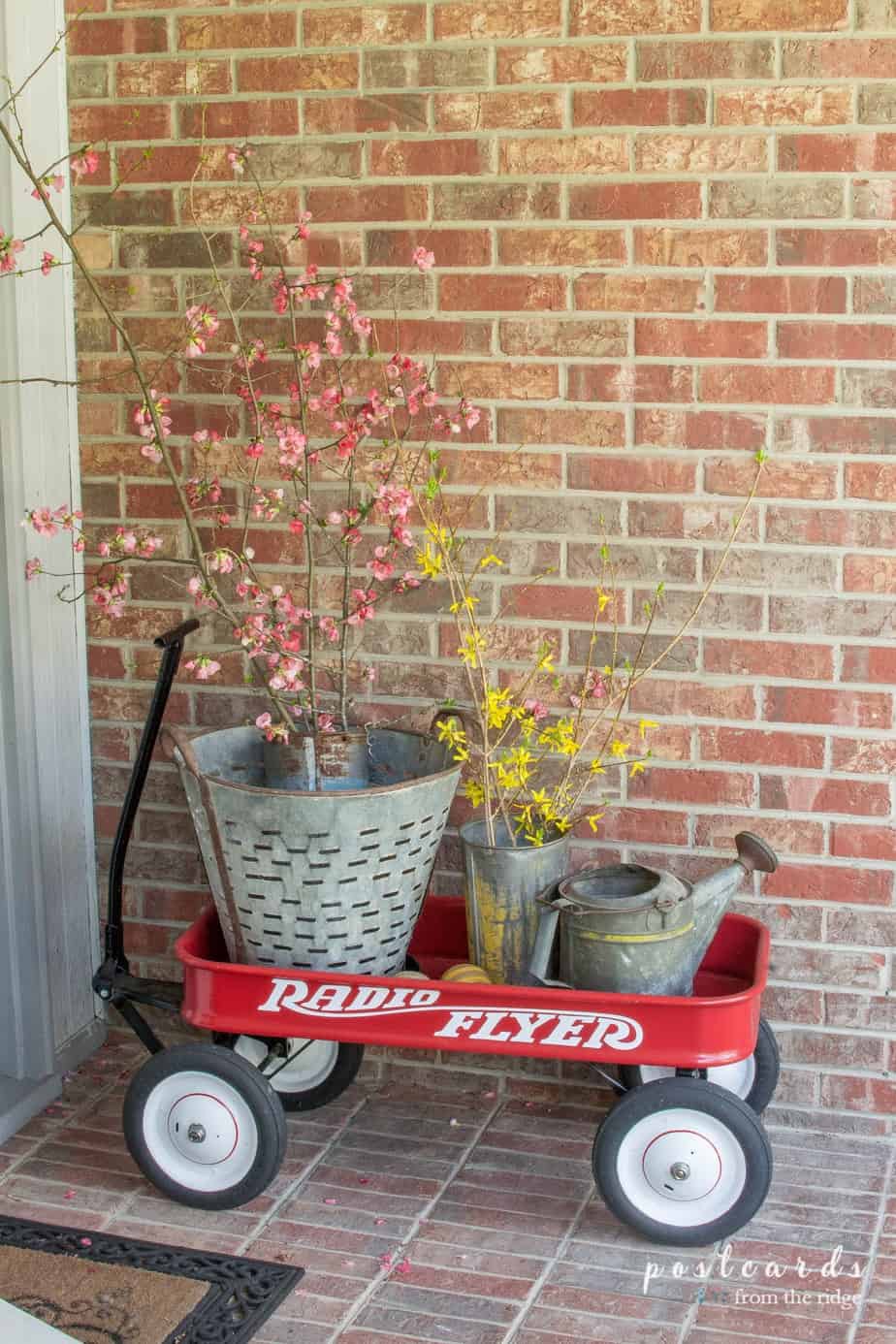 radio flyer wagon with clipped branches and vintage metal buckets