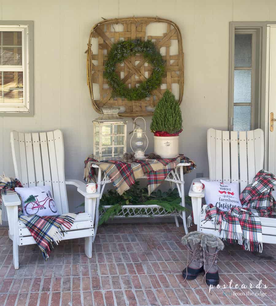 Christmas front porch decor with vintage tobacco basket, lanterns, rosemary topiary