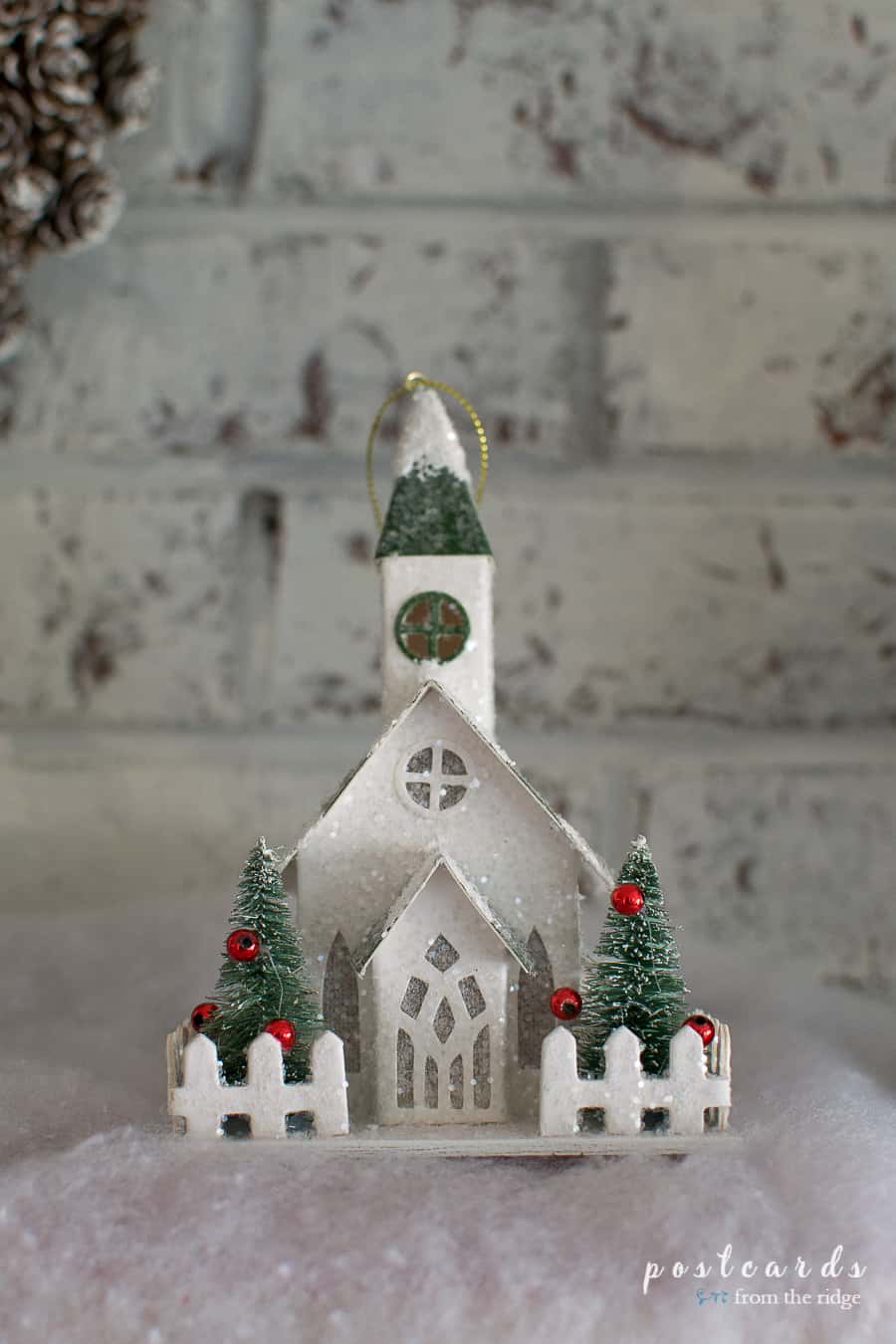 little snow covered paper church on a farmhouse Christmas mantel