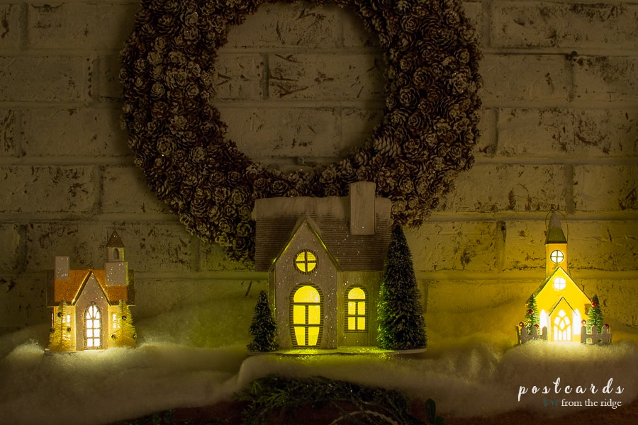 little houses on a mantel lit up at night