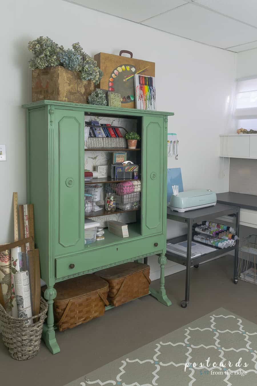 vintage China cabinet painted a fresh green with art supplies inside