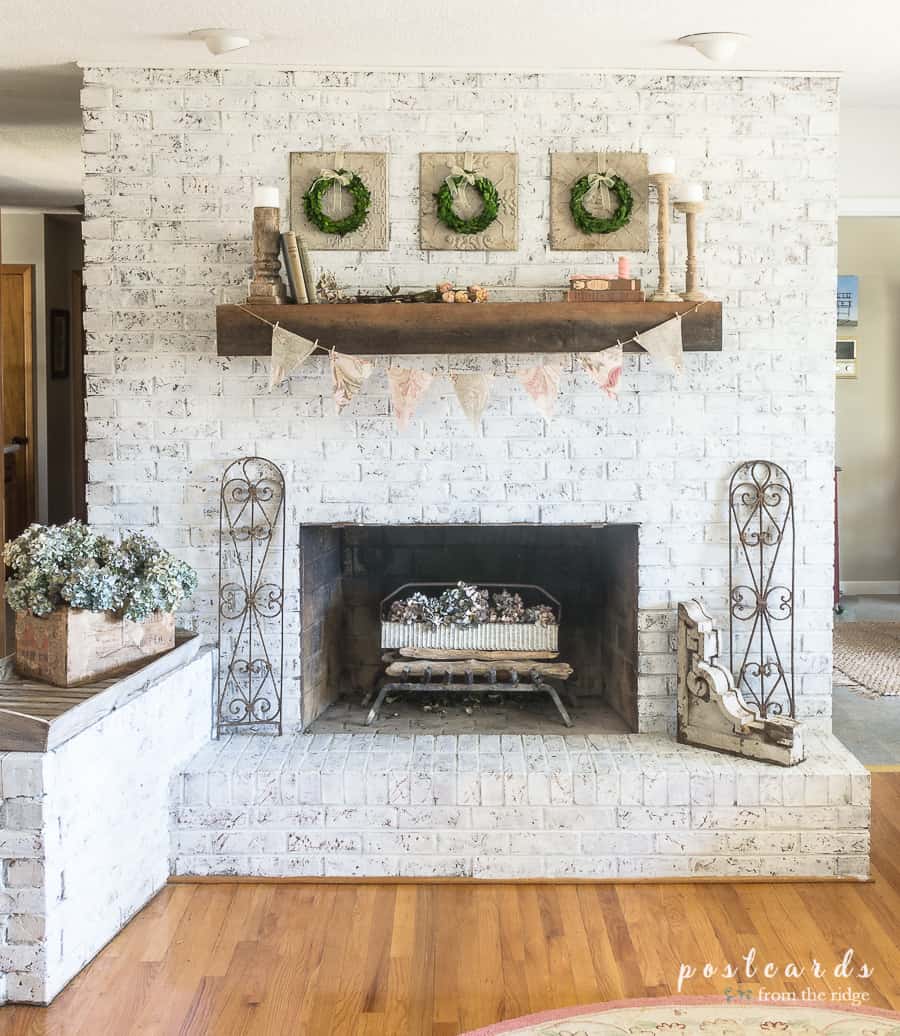 white brick fireplace with spring decor