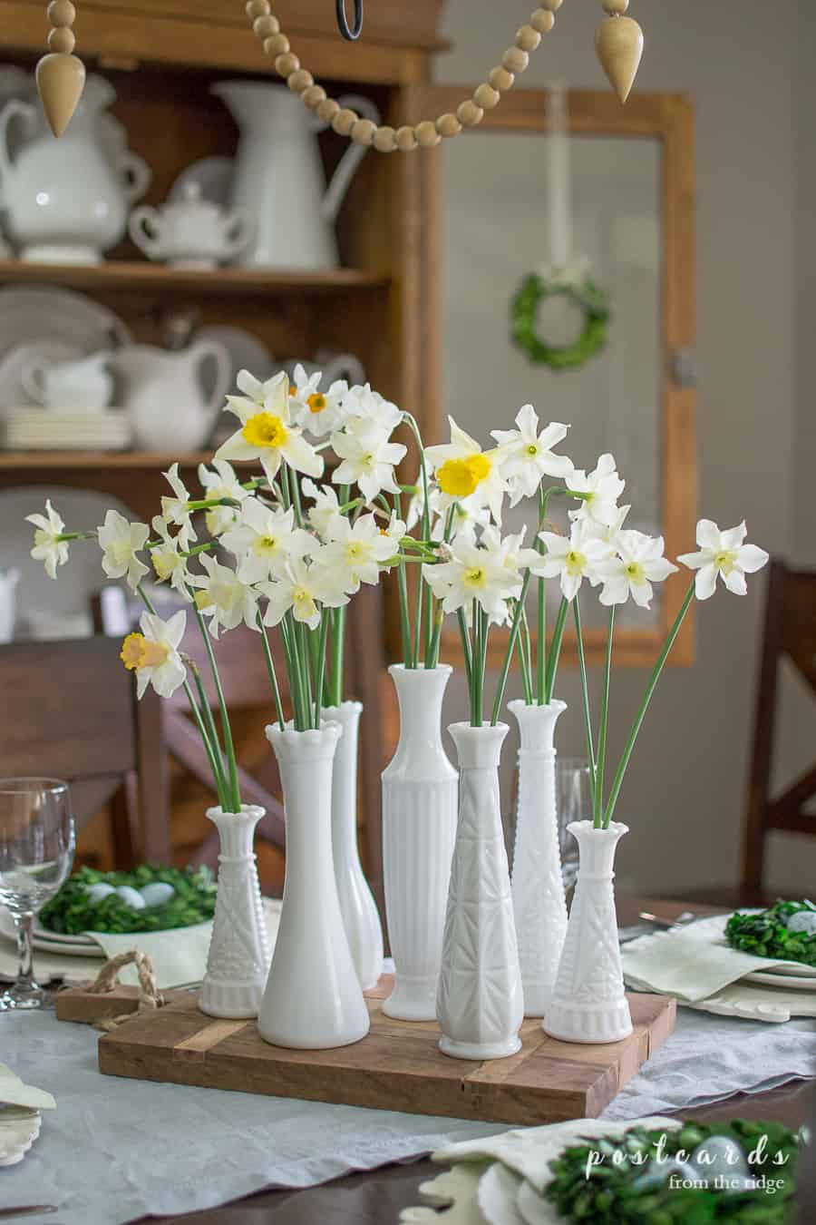 milk glass vases with daffodils