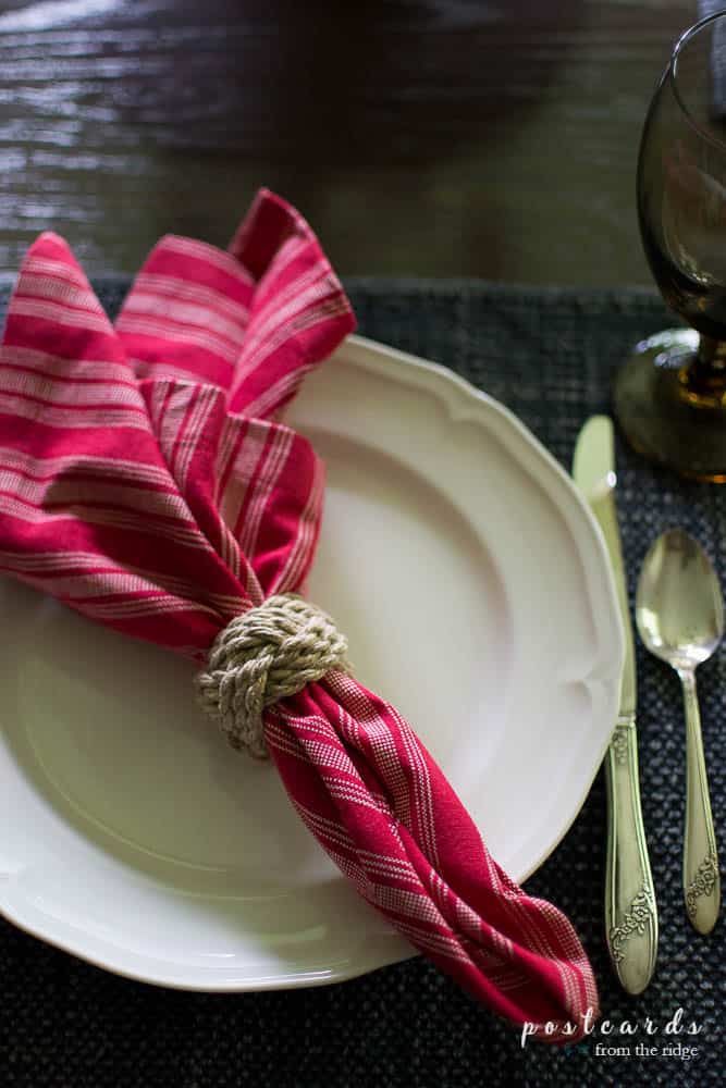 red striped napkin on a white plate and blue stonewashed placemat
