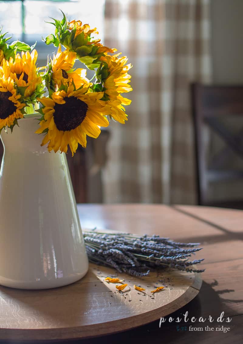 lavender bundle and sunflowers in a white enamel pitcher