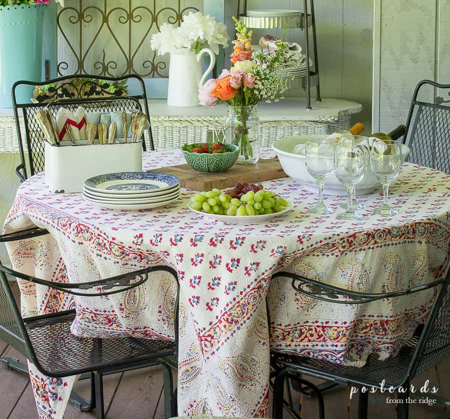 outdoor table with vintage items and flowers