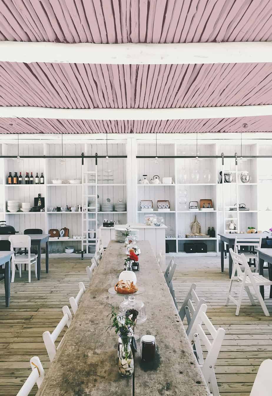 rustic dining space with white walls and blush accents