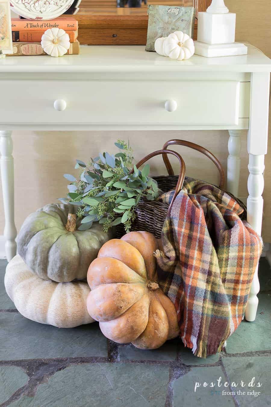 fall pumpkins and plaid blanket