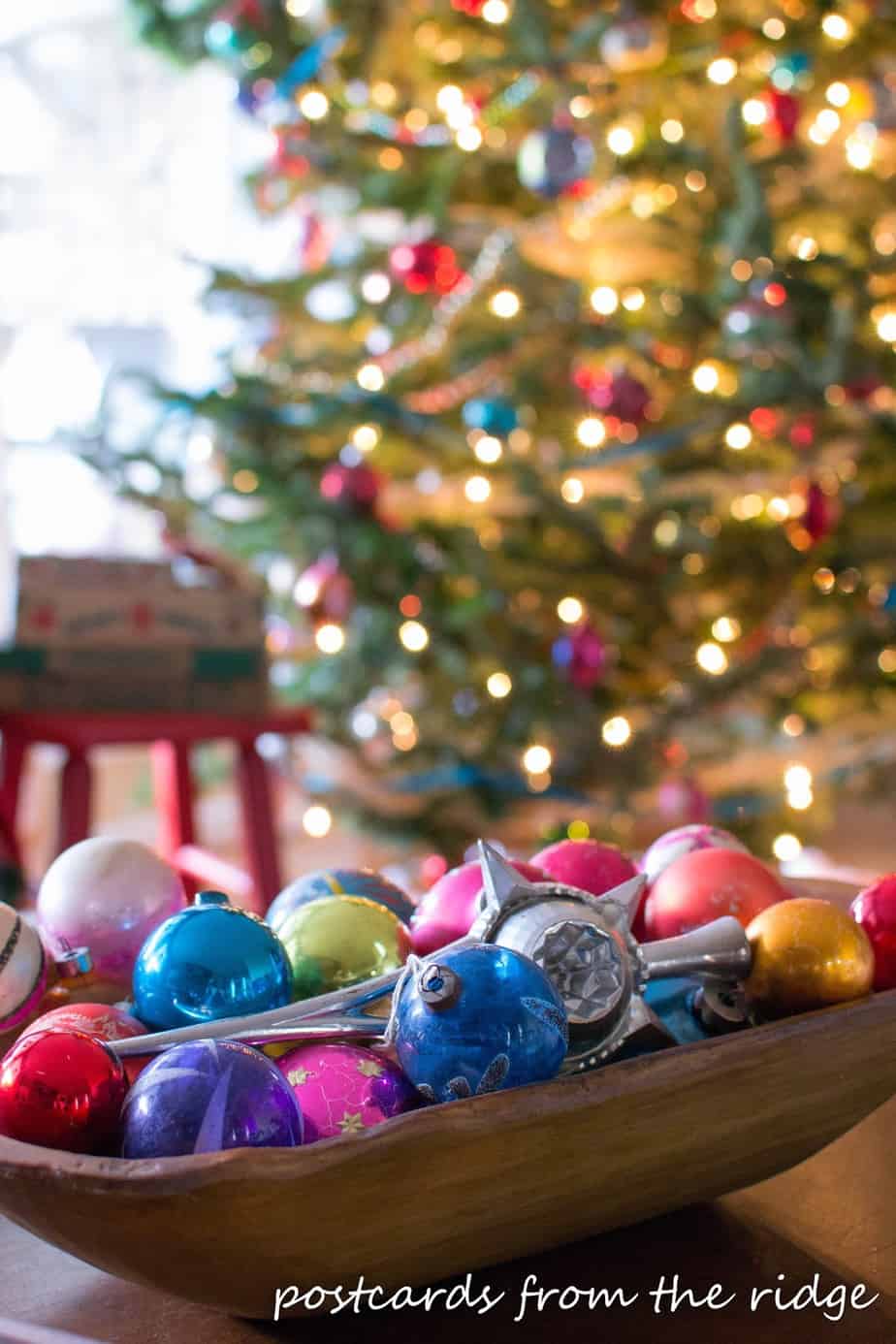 colorful old mercury glass ornaments in a wooden bowl
