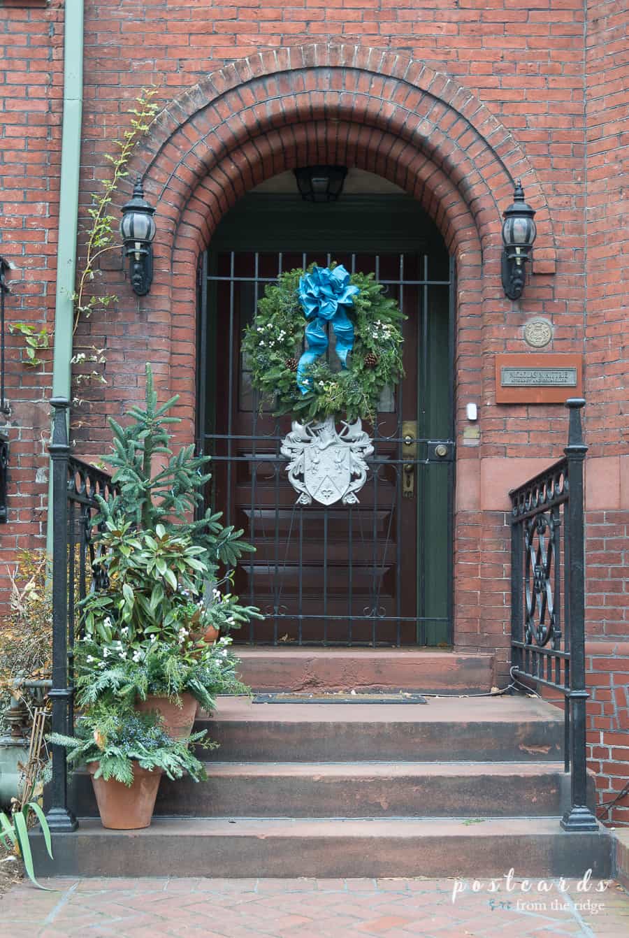 arched front door with Christmas wreath
