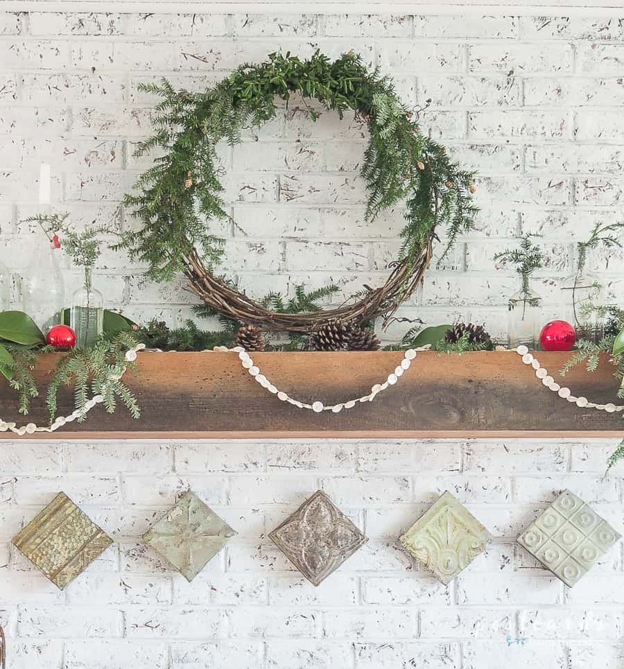 fireplace mantel with grapevine wreath