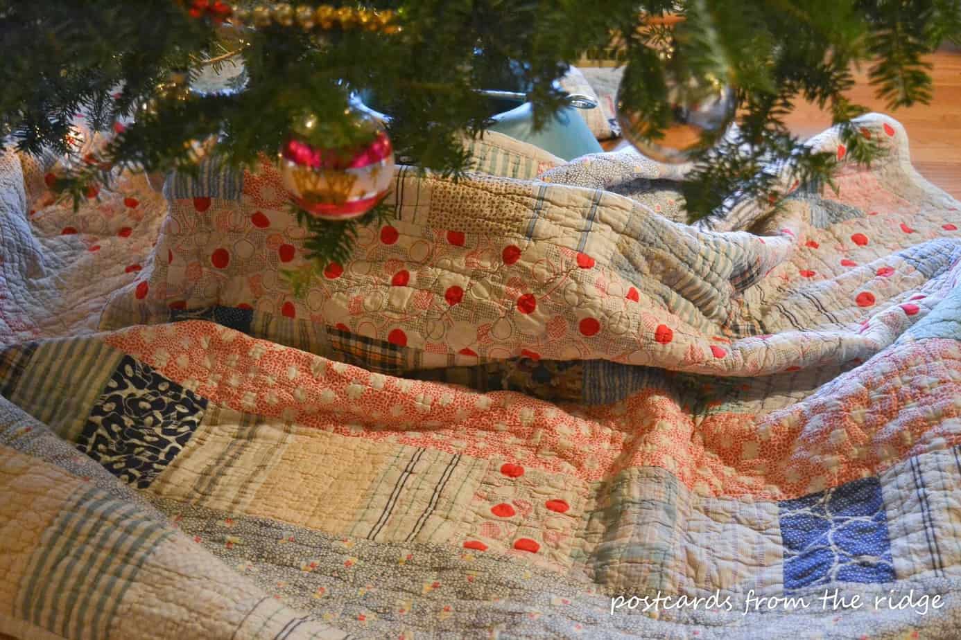 old quilt used as Christmas tree skirt