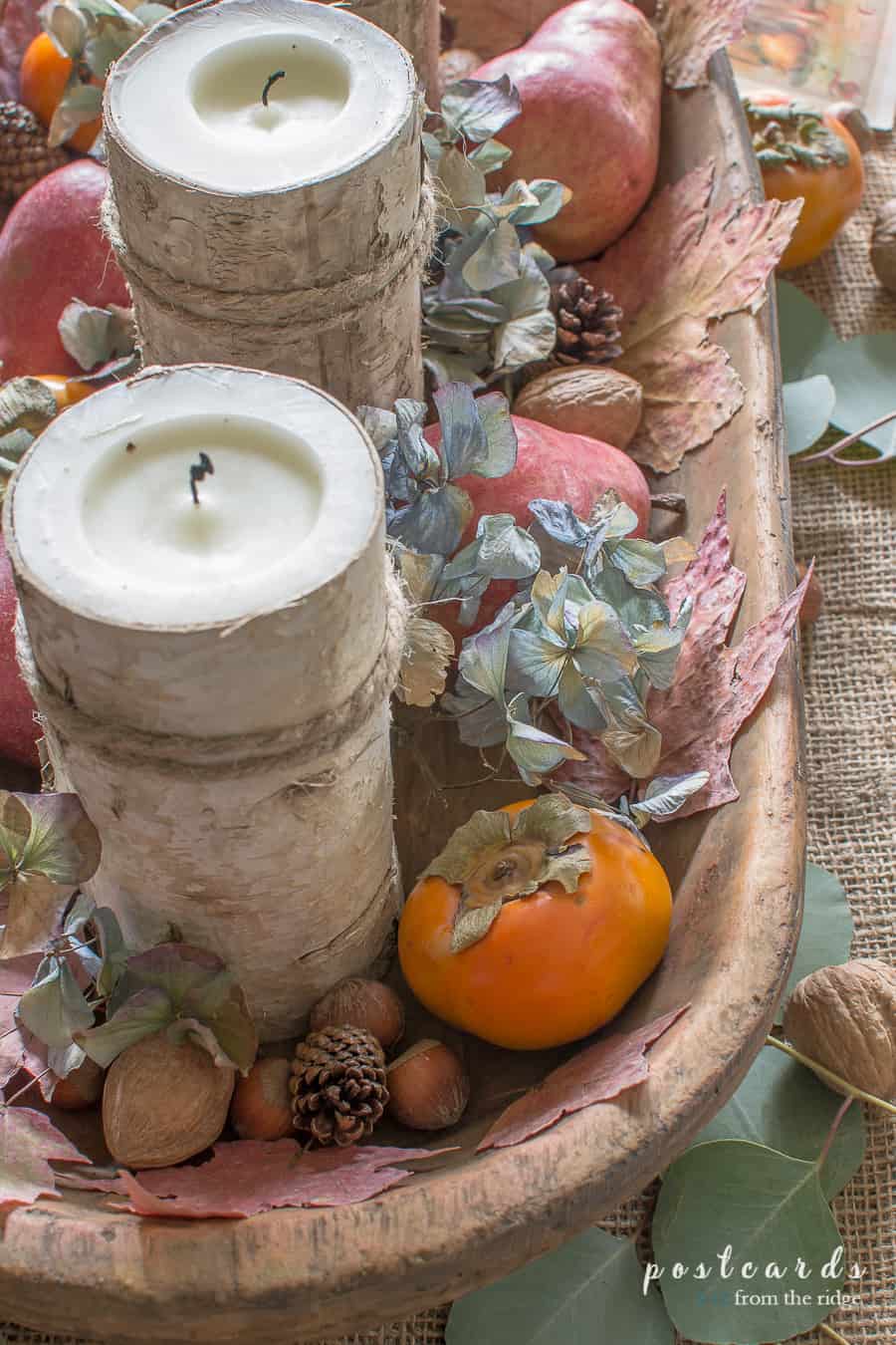 birch wrapped candles with persimmons and nuts