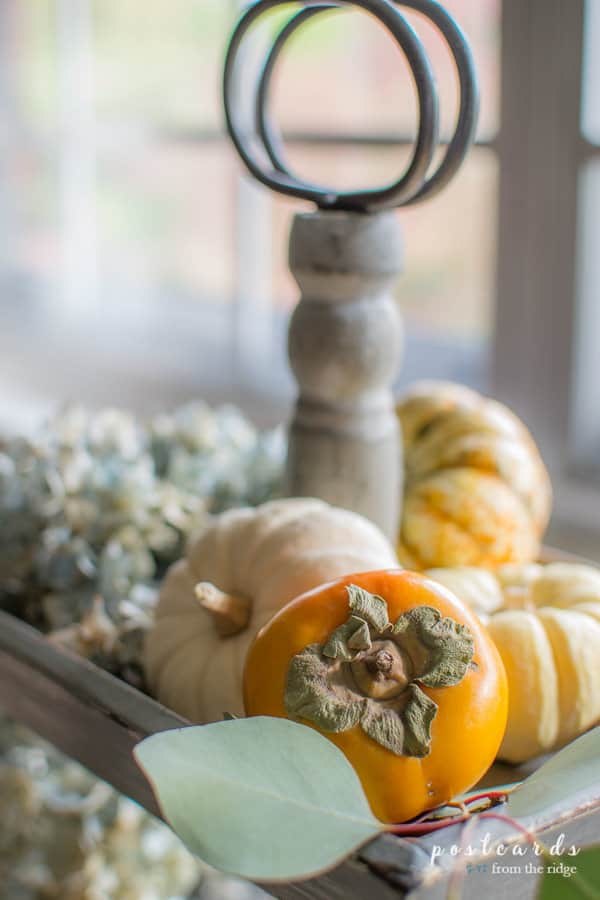 dried hydrangeas and pumpkins on a wooden 3 tier tray