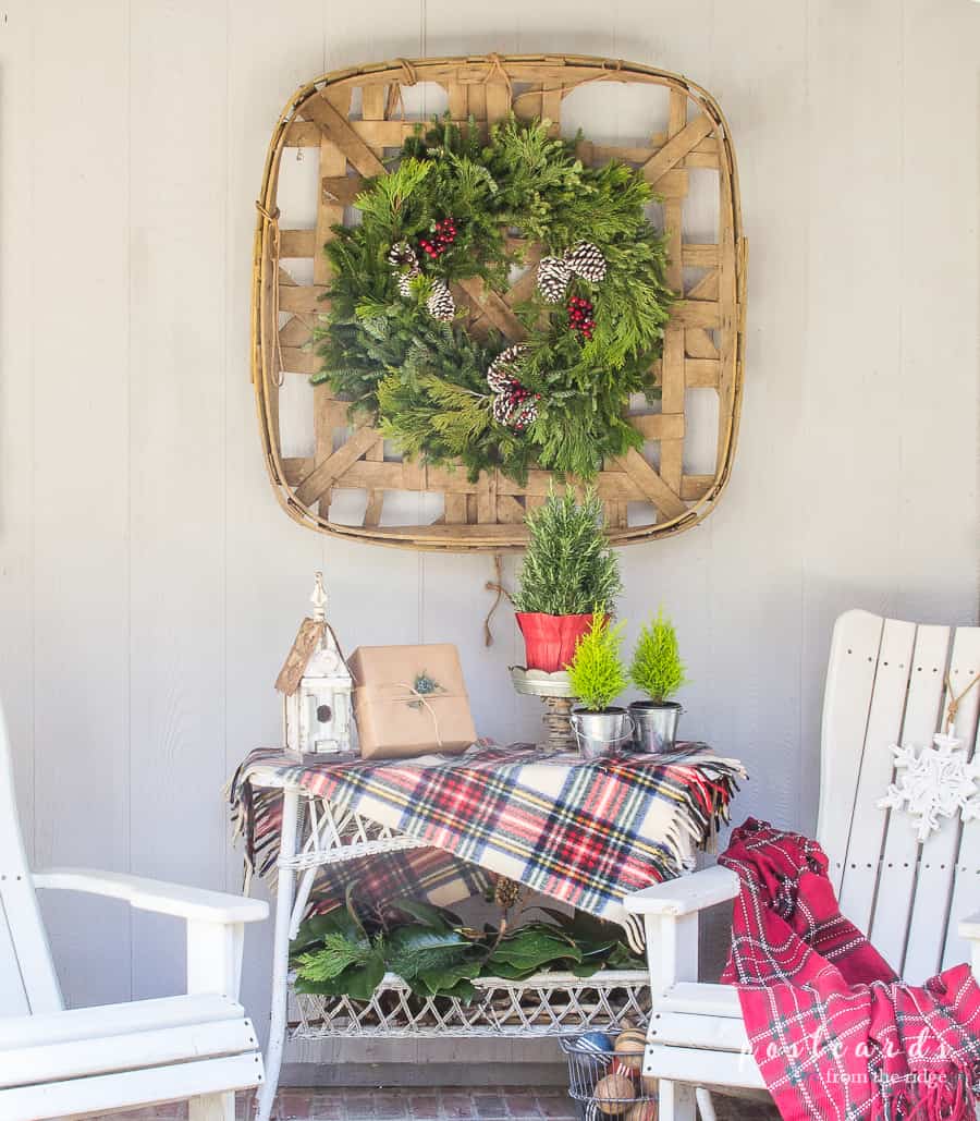 white adirondack chairs and Christmas decor on a porch