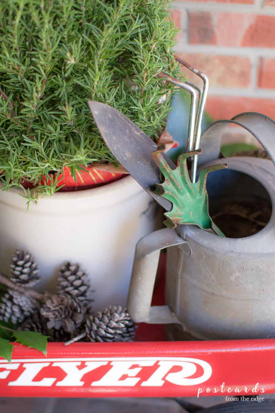 vintage watering can and gardening tools