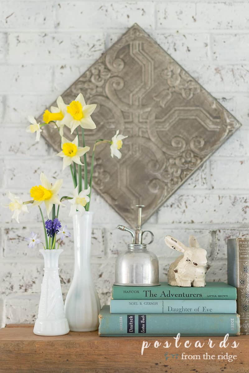 spring decor with vintage books and milk glass vases