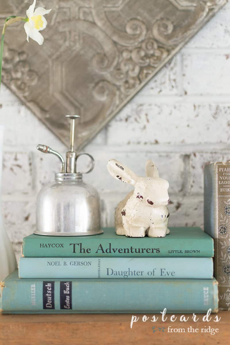 vintage books and cast iron bunny statue