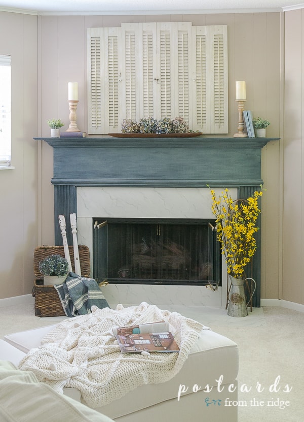 blue painted fireplace mantel and cozy decor