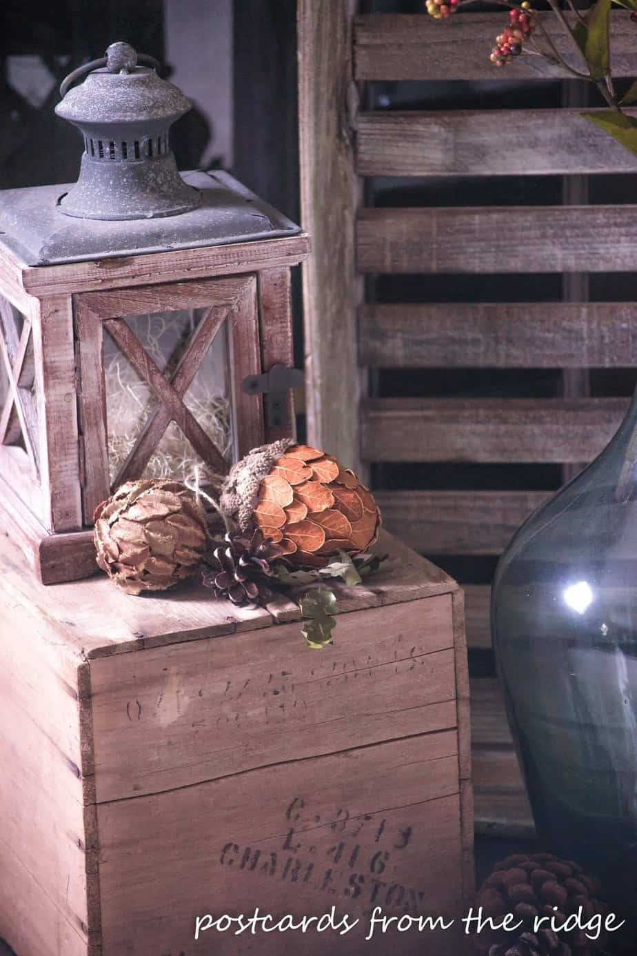 wood lantern and fall decor on old wooden crate