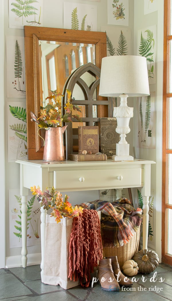 entry with white table and lamp and traditional colored fall decor