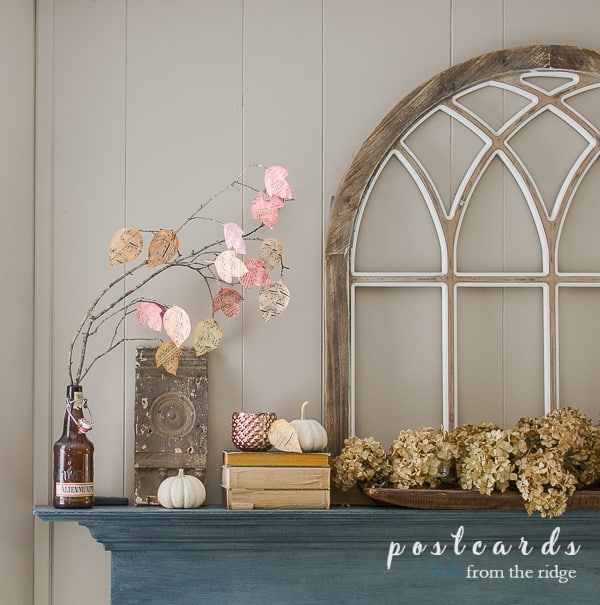 diy watercolor paper leaves with dried hydrangeas and cathedral window on fireplace mantel
