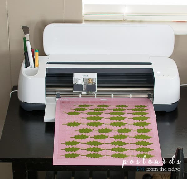 felt holly leaves being cut by cricut machine