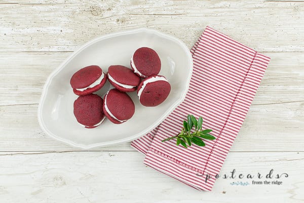 red velvet whoopie pies on a white place and red stripe napkin
