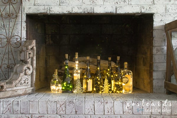 wine bottles with lights inside a fireplace