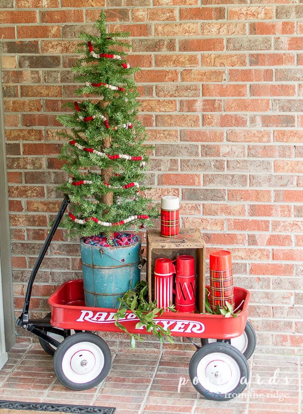 red wagon with red thermoses and tree in turquoise wooden ice cream bucket