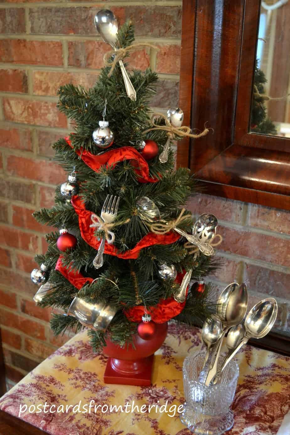 mini christmas tree with baby spoons and red ribbon