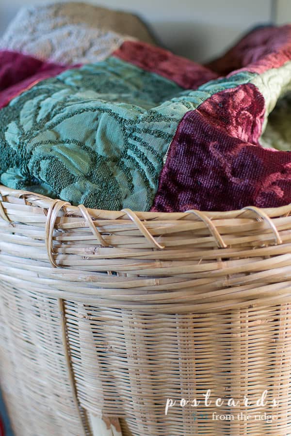 vintage velvet quilt in large woven basket
