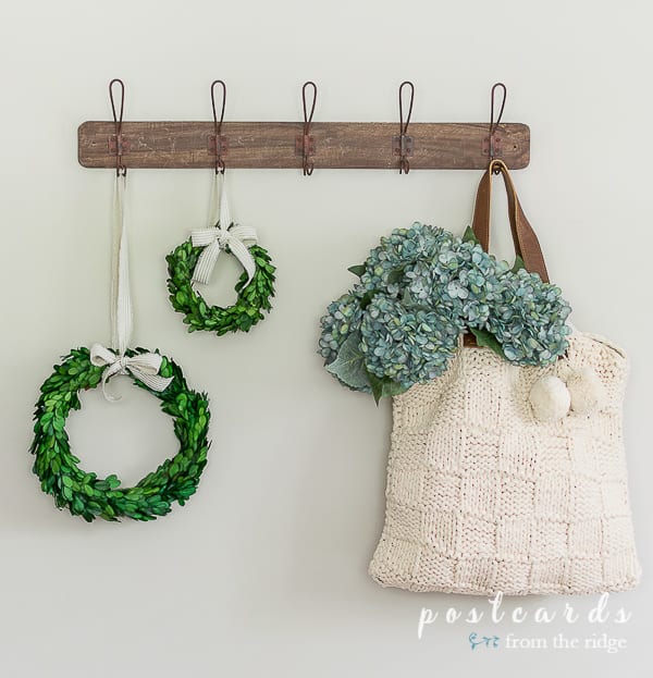 faux blue hydrangeas in a macrame tote bag with preserved boxwood wreaths