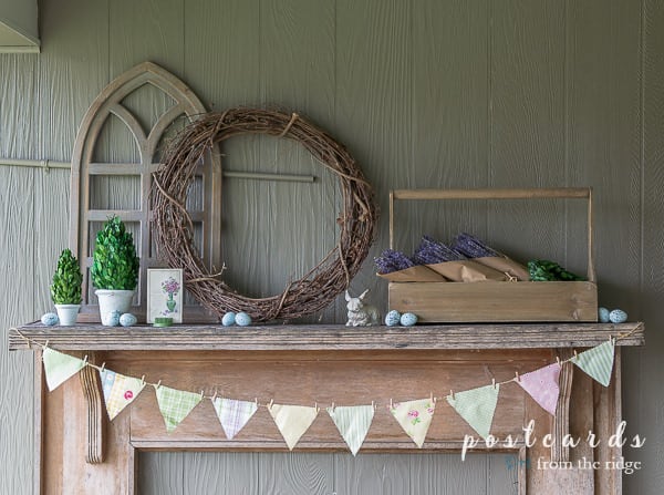 rustic spring mantel with fabric banner and cottage decor
