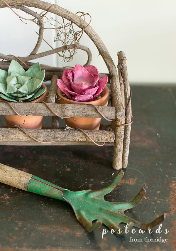 vintage garden hand rake and flowers made from paper egg cartons