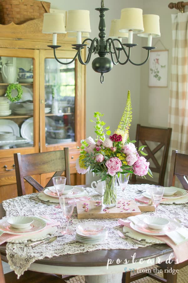 spring tablescape with lace table square and pink peony centerpiece