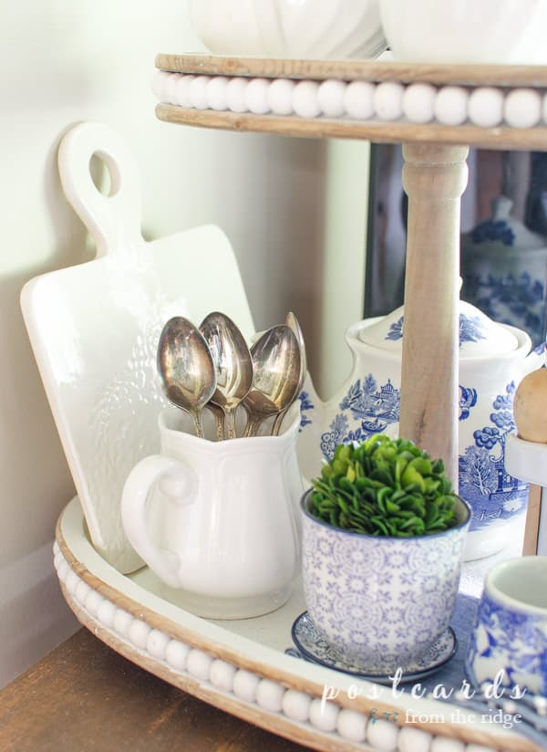 tiered tray with blue, white, and green vintage decor