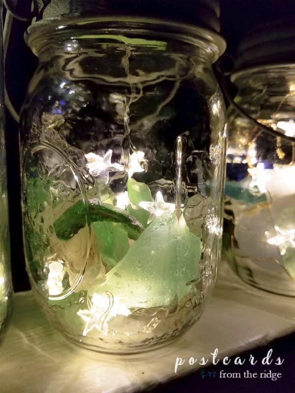 mason jar lanterns with sea glass and solar powered lids with fairy lights