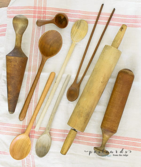 collection of vintage wooden spoons and kitchen utensils