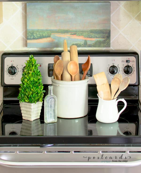 wooden spoons and utensils in stoneware crock and pitcher