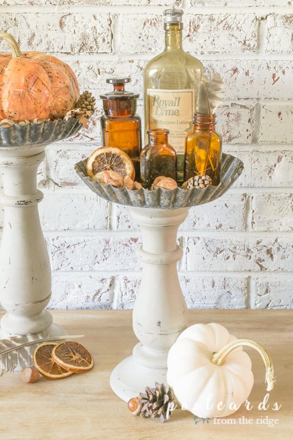 fall decor on diy pedestal stands made with wooden candleholders and tart pans