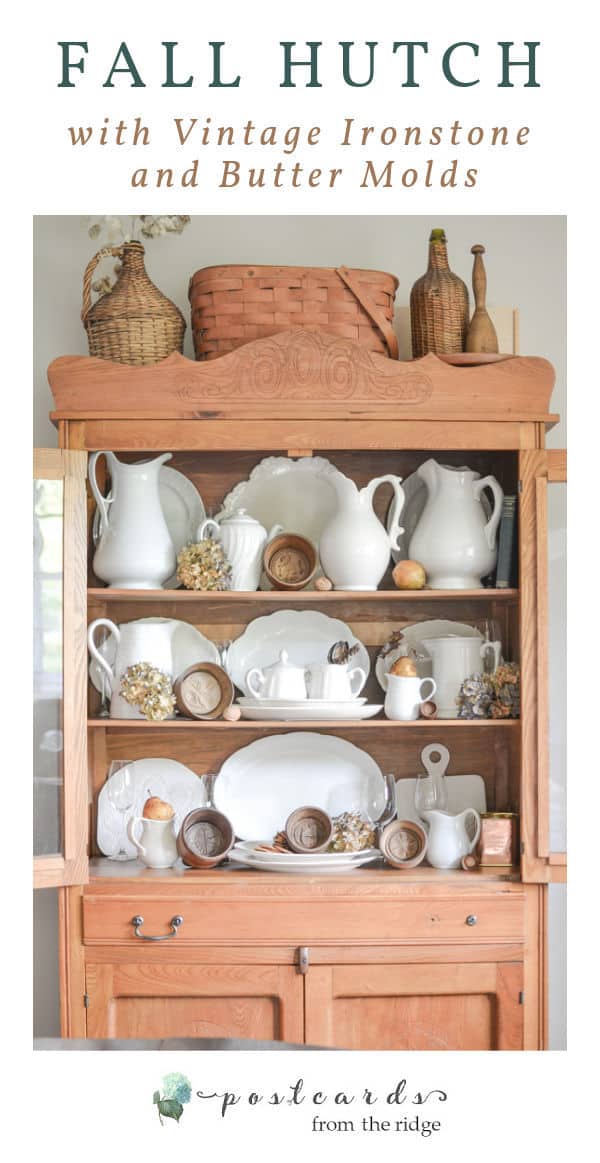 vintage white ironstone pitchers and platters, wooden butter molds, dried hydrangeas in an antique oak hutch